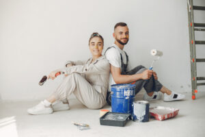 Family repairs. Couple at home. Woman in a overalls